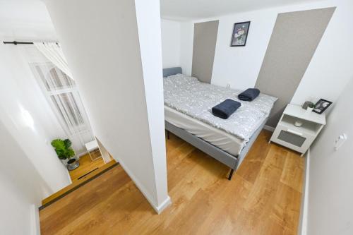 a small bedroom with a bed in a white room at Charming apartment in Damjanich str., Lucas in Budapest