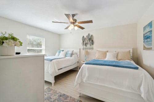 a bedroom with two beds and a ceiling fan at Bikes, Yard and Fire Pit at Upscale Lecanto Home! in Lecanto