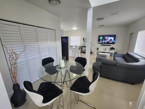 a living room with a glass table and chairs at The 305 in Miami