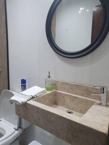 a bathroom with a sink and a mirror at Departamento Nuevo, Asunción in Asunción