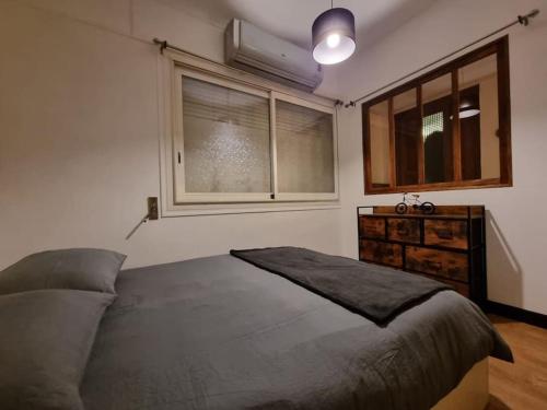a bedroom with a bed and a window at Chez Sam in Saint-Laurent-de-la-Salanque