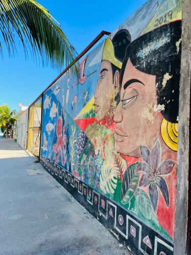 a mural of a man and a woman on a wall at Casa Almea Sisal in Sisal