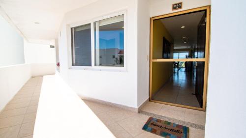 a hallway of a house with a large window at Apartment Alcatraz, 4BR Oasis with Breathtaking Vi in Nuevo Vallarta 