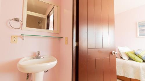 a bathroom with a sink and a mirror at Apartment Alcatraz, 4BR Oasis with Breathtaking Vi in Nuevo Vallarta 