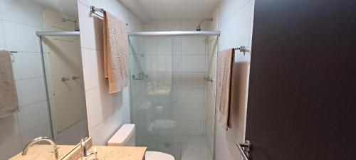 a bathroom with a shower and a toilet and a sink at Flat Sorriso - Beach Class Conventions in Recife