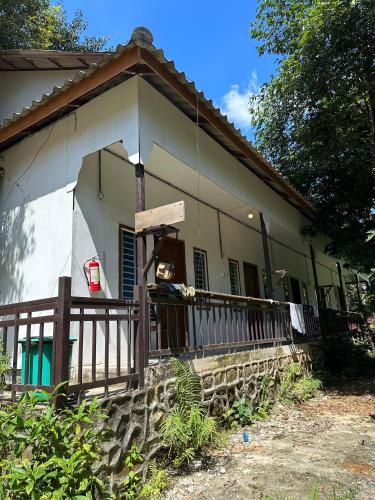 a small house with a porch and a fence at Nest Jungle in Koh Rong