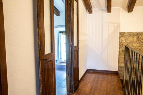 an open door in a hallway with a stone wall at Il Borghetto in Agazzano