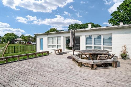 a patio with a table and an umbrella at Waterfront Bliss- Ultimate Tilghman Retreat home in Tilghman