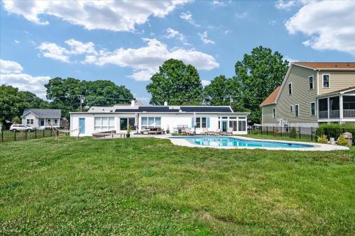 a house with a pool and a yard at Waterfront Bliss- Ultimate Tilghman Retreat home in Tilghman