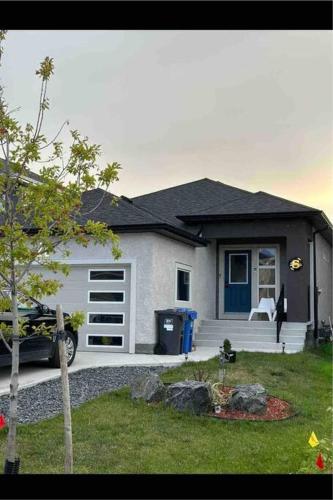 a house with a car parked in front of it at Guest expertise in Winnipeg
