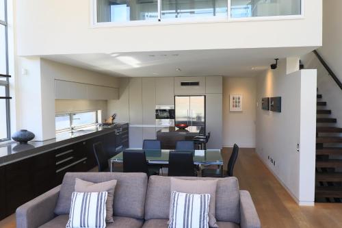 a living room with a couch and a table at Lakeshore Springs Apartments in Wanaka