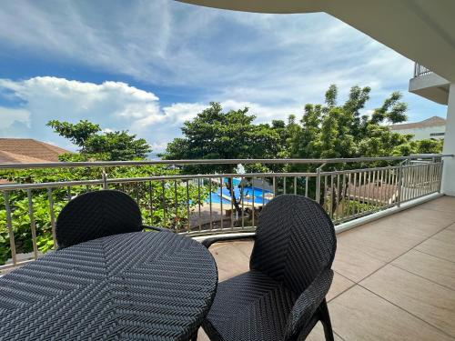 a couple of chairs sitting on a balcony at Mactan Resort by 1521 in Mactan