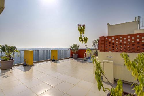a balcony with plants and a view of the ocean at Premium 2BHK apartment with Pool Access in Vasco Da Gama
