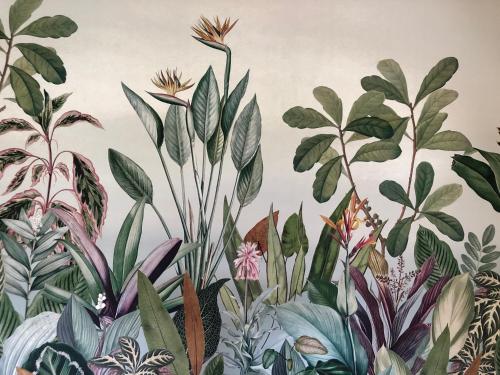 a mural of plants and flowers on a wall at Villa Diamant Bleu in Le Diamant