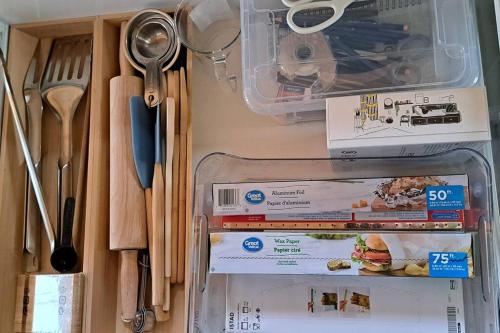 a drawer filled with food and utensils on a table at Islander Lodge - Lochaber Lake Lodges in Antigonish