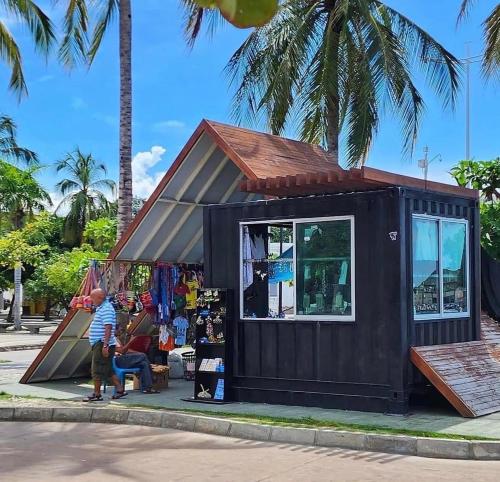 a small black tiny house on the side of a street at Santa Sophia Del Mar B&B hotel in Santa Marta