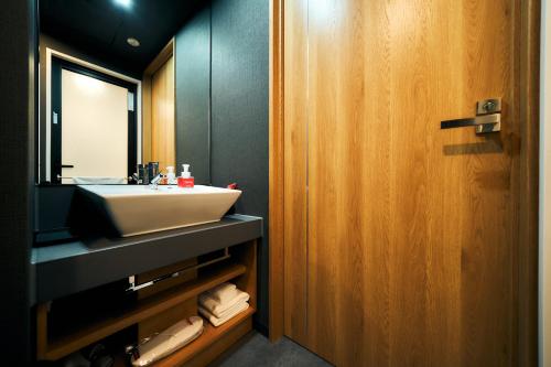 a bathroom with a sink and a mirror at Rakuten STAY Kyoto Station in Kyoto