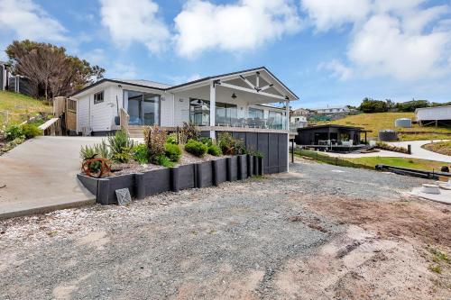 a house that is sitting on top of a driveway at Seaglass - Karikari Peninsula Holiday Home in Kaitaia