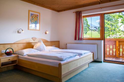 a bedroom with a large bed in front of a window at Brandstätterhof in Schladming