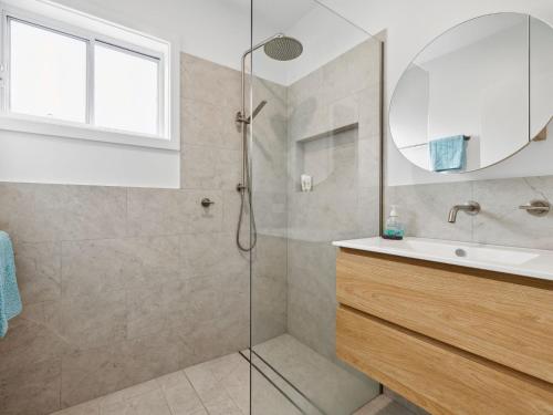 a bathroom with a shower and a sink at Little Kim Close in Woolgoolga