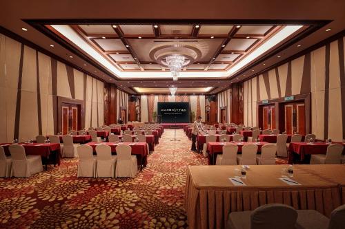 a banquet hall with tables and chairs in a room at Mardhiyyah Hotel and Suites in Shah Alam