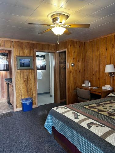 a bedroom with a bed and a ceiling fan at Lazy Duck Inn in West Yellowstone
