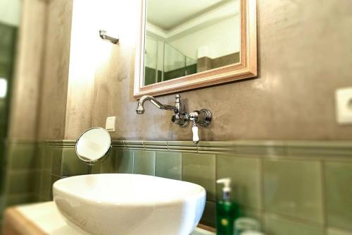 a bathroom with a white sink and a mirror at Palais Esplanade Hamburg - Adults Only in Hamburg