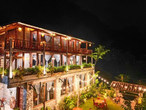 a building with a balcony with plants on it at Ba Be Jungle Houses in Ba Be