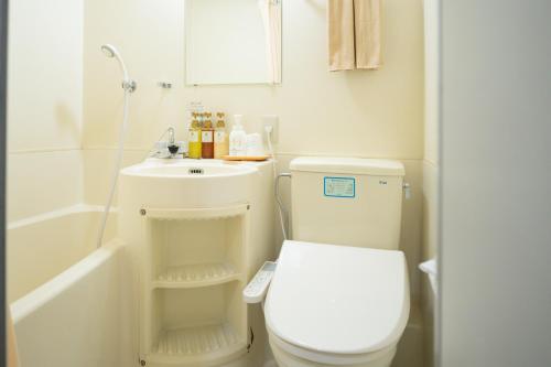 a bathroom with a white toilet and a sink at Yataro in Nagasaki