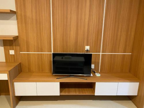 a tv sitting on top of a wooden cabinet at Formosa Spacious Apartments with Netflix & Pick Up Service by MESA in Nagoya