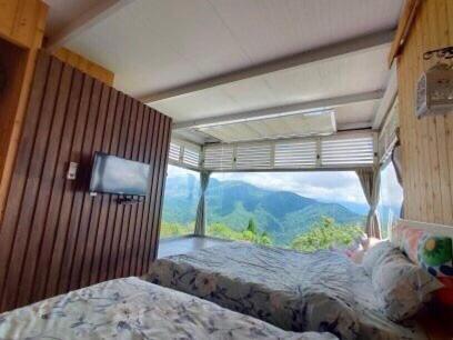 a room with two beds and a view of a mountain at Villa Relax in Renai