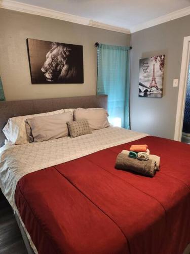 a bedroom with a large bed with a red blanket at Blue Shark *G15* @ Montrose Private 1BR King Apartment in Houston