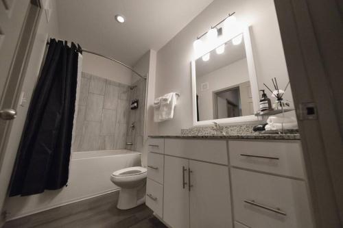 a bathroom with a sink and a toilet and a mirror at Optimum - Groovy Sanctuary! in Birmingham