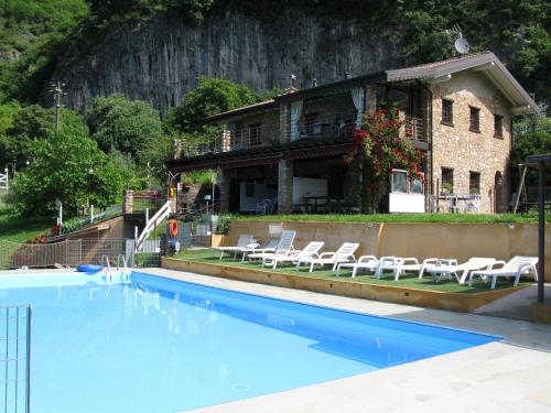 a house with a swimming pool in front of a building at Chalet della Rota in Marone