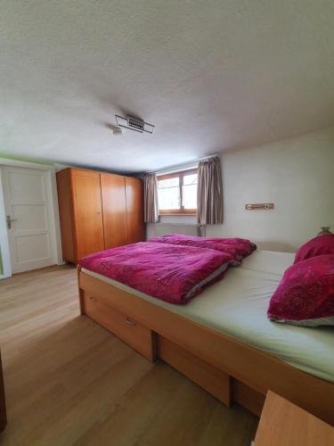 - une chambre avec un grand lit et des draps violets dans l'établissement Ferienhaus in Stockheim, à Stockheim