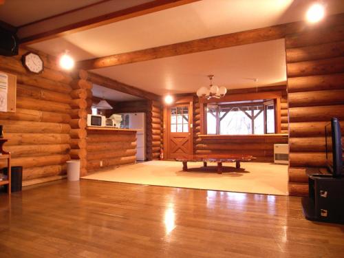 a room with a bench in the middle of a room with wooden walls at Cottage All Resort Service / Vacation STAY 8424 in Inawashiro