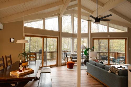 a living room with a couch and a table at Sweet William A Lake Naomi Chalet Membership in Pocono Pines