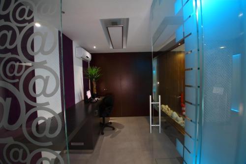 an office with a glass door and a desk at Hotel Africa in Maputo