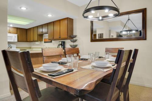 ein Esszimmer mit einem Holztisch und Stühlen in der Unterkunft PARK STATION 122 condo in Park City