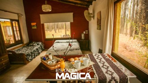 a living room with a table and a couch at Cabañas en Malargue in Malargüe