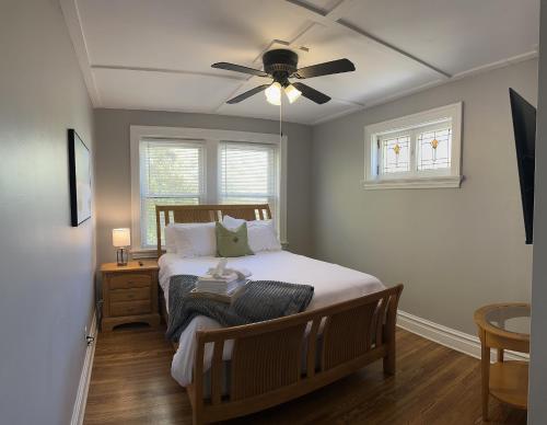 a bedroom with a bed with a ceiling fan at New 3 Bedroom City Escape in Saint Louis