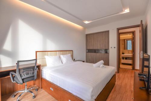 a bedroom with a bed and a desk and a chair at Vinhomes Metropolis luxury Hotel & Residence in Hanoi