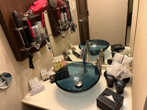 a bathroom with a blue sink and a mirror at 艶横浜町田店 adult only in Yokohama