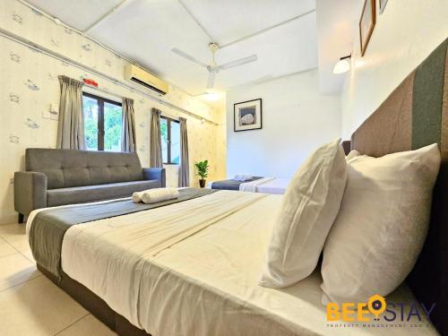 a bedroom with a large bed and a couch at Bangsar Three Storey Luxury Landed House 19PAX in Kuala Lumpur