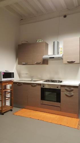 a kitchen with a stove and a counter top at Palazzo Dodici Rondini in Foligno