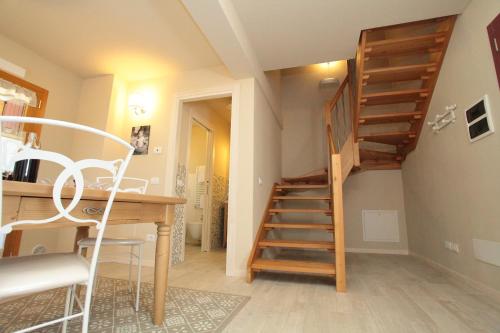 a staircase in a room with a desk and a table at Albergo Diffuso Polcenigo B.Vittorio in Polcenigo