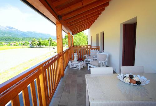a balcony of a house with a table and chairs at Albergo Diffuso Polcenigo B.Vittorio in Polcenigo