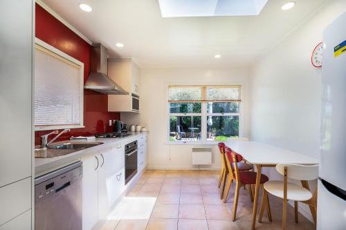 a kitchen with a table and chairs and a window at Sunny Richmond Retreat in Richmond