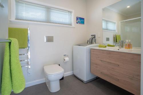 a bathroom with a white toilet and a sink at Brougham Street B and B in Nelson