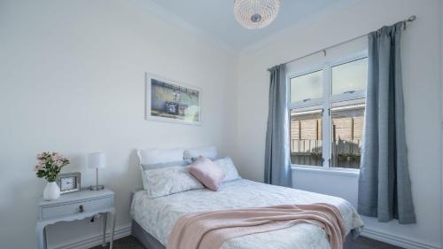 a bedroom with a bed and a window at Brook Nest in Nelson